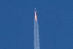 Virgin Galactic's passenger rocket plane VSS Unity, carrying billionaire entrepreneur Richard Branson and his crew, begins its ascent to the edge of space above Spaceport America, near Truth or Consequences, New Mexico, July 11, 2021.