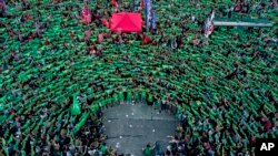 Pro-choice activists in favor of decriminalizing abortion raise green handkerchiefs as they rally outside Congress in Buenos Aires, Argentina, Feb. 19, 2019. A rise in global populism is threatening access to abortion, a group of female leaders warned Monday.