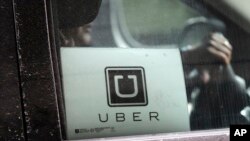 FILE - In this March 15, 2017, file photo, an Uber car drives through LaGuardia Airport in New York. Uber is now offering to take patients in every U.S. market where it operates to their next medical appointment. 