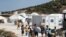 Refugees and migrants from the destroyed Moria camp enter a new temporary camp on the island of Lesbos, Greece, Sept. 20, 2020. 