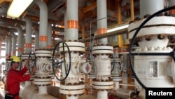 FILE - An Iranian man works on an oil production platform at the Soroush oil fields in the Persian Gulf, south of the capital Tehran, July 25, 2005.