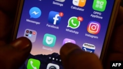 FILES - This photo taken on March 22, 2018 shows apps for Facebook, Instagram and other social networks on a smartphone.