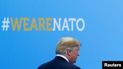 U.S. President Donald Trump walks during the welcoming ceremony at the start of a NATO summit at the Alliance’s headquarters in Brussels, Belgium, July 11, 2018. 