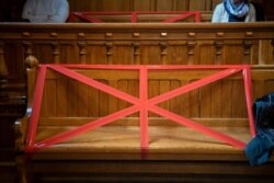 FILE - Benches and tables are taped to ensure social distancing protocols, in a courtroom in Bremen, Germany, March 20, 2020.