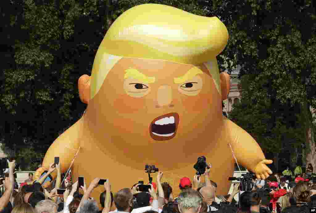 A six-meter high cartoon baby blimp of U.S. President Donald Trump is flown as a protest against his visit, in Parliament Square in London, England.