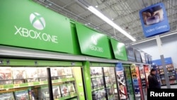 FILE - A man looks at video games at Wal-Mart ahead of Black Friday in Los Angeles, California