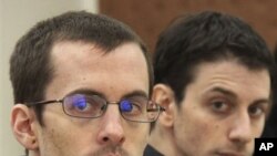 A picture released by Iran's state-run Press TV shows US hikers Shane Bauer (L) and Josh Fattal (R), detained in Iran on spying charges, during the first session of their trial, February 6, 2011.