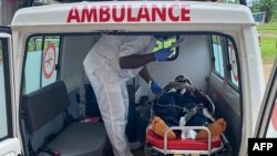 FILE - A handout photo from Medecins Sans Frontieres (Doctors Without Borders) on Oct. 25, 2020, shows a medic treating a victim of a shooting at a bilingual school in Kumba, Cameroon, the day before.