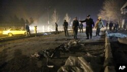 Afghan security forces inspect the site of a suicide attack near the Russian embassy in Kabul, Afghanistan, Jan. 20, 2016. 