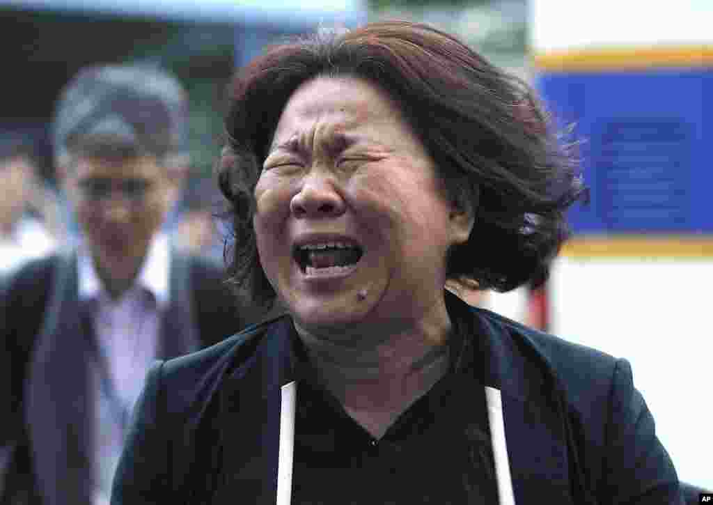 A family member of passengers aboard the sunken ferry Sewol cries after a pretrial hearing for crew members of the ferry at Gwangju District Court in Gwangju, South Korea, June 10, 2014.