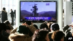 9일 한국 서울역에서 북한의 미사일 발사 기간 연장 뉴스를 시청하는 주민들.