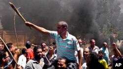 Egyptians chant slogans during clashes between supporters and opponents of Egypt's president and his Muslim Brotherhood in Luxor, Egypt, June 19, 2013.