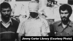 FILE - An American hostage is paraded before a crowd outside the U.S. embassy compound in Tehran, Iran, Nov. 9, 1979.