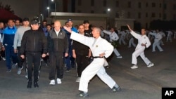 In this Dec. 16, 2018 photo released by the Egyptian Presidency, Egyptian President Abdel-Fattah el-Sissi inspects cadets during their morning exercises at the national Military Academy, in a suburb of Cairo, Egypt. 