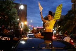 Demonstrators protest over the deaths of George Floyd and Breonna Taylor, June 1, 2020, in Louisville, Ky. Breonna Taylor, a black woman, was fatally shot by police in her home in March.
