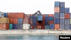 A crane arranges containers at the Port of Zanzibar on the island of Zanzibar, July 19, 2012. 
