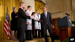 President Barack Obama turns to shake hands with Dr. Kent Brantly, 33, an Ebola survivor, after speaking at a White House event with American health care workers fighting Ebola, Oct. 29, 2014.