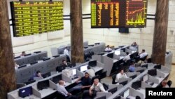 Traders work at Egypt's Stock Exchange in Cairo, July 3, 2013. 