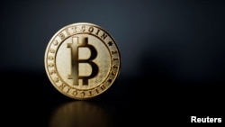 FILE PHOTO: A bitcoin is seen in an illustration picture taken at La Maison du Bitcoin in Paris
