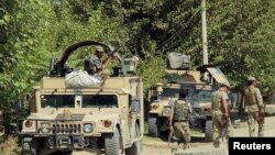 FILE - Afghan security forces prepare themselves during a battle with insurgents on the outskirts of Kunduz, Afghanistan, Aug. 21, 2016. 
