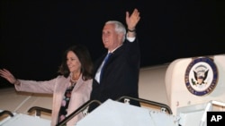 U.S. Vice President Mike Pence waves with his wife Karen as they exit from Air Force Two upon landing at Yokota Air Base in Fussa, on the outskirts of Tokyo, Nov. 12, 2018.