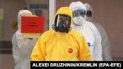 RUSSIA -- Russian president Vladimir Putin (front) wearing a yellow protective suit visits a hospital for patients with suspected COVID-19 disease caused by the SARS-CoV-2 coronavirus in the Kommunarka settlement in New Moscow, Russia, 24 March 2020. 
