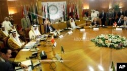 Arab League secretary-general Nabil Elaraby, fourth left, chairs an Arab League committee emergency meeting on Syria at the league’s headquarters in Cairo, Egypt, Thursday, May 23, 2013, ahead of an international peace conference to end the country’s civi