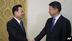 Choe Ryong Hae, left, vice chairman of the Central Committee of North Korea's ruling party shakes hands with Song Tao, the head of China's ruling Communist Party's International Liaison Department, at the Mansudae Assembly Hall, in Pyongyang, Friday, Nov. 17, 2017. 