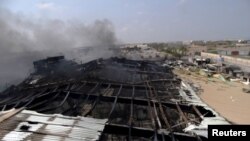 Smoke rises from a milk factory hit by an airstrike in Yemen's western port city of Houdieda, April 1, 2015. 