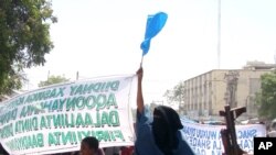 An attendant at the Shamo Hotel is seen next to the site of a bomb explosion in Mogadishu, Somalia, Dec. 3, 2009.