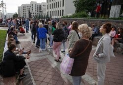 People stand in a line outside the national elections commission to sign complaints about the removal of Viktor Babariko and Valery Tsepalko from the ballot for the Aug. 9 election in Minsk, Belarus, July 15, 2020.