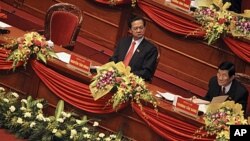 Politburo member Truong Tan Sang, right, reads a document while Vietnamese Prime Minister Nguyen Tan Dung looks on at the opening ceremony of the 11th National Congress of the Vietnamese Communist Party in Hanoi, Vietnam on January 12, 2011