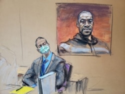 FILE - Former Minneapolis police Officer Derek Chauvin sits in front of a picture of George Floyd displayed during Chauvin's trial for second-degree murder, third-degree murder and second-degree manslaughter in the death of Floyd in Minneapolis.