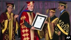 Afghan President Hamid Karzai receives an honorary degree from his Indian counterpart Pranab Mukherjee, second right, at the Lovely Professional University in Jalandhar, India, May 20, 2013.