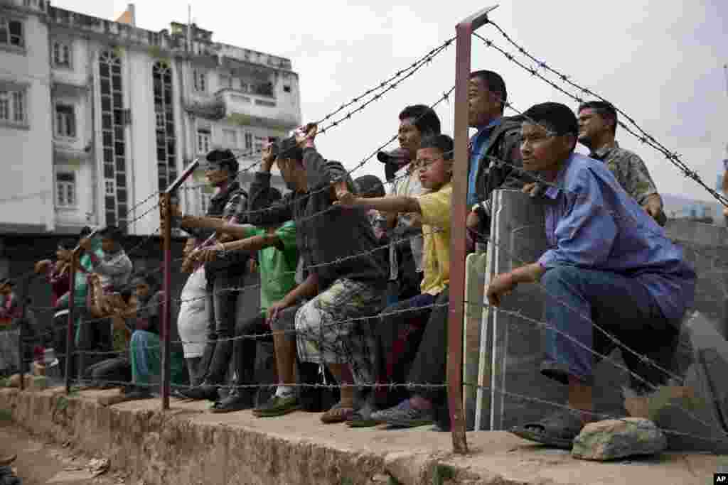 Locals gather to a rescue operation at the site of a budget hotel that collapsed in Saturday&rsquo;s earthquake, in Kalanki neighbourhood of Kathmandu, Nepal.