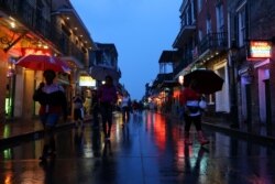 Tourists walk on Bourbon Street during Hurricane Barry in New Orleans, La., July 13, 2019.