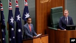 Indonesia's President Joko Widodo, left, address the Australian Parliament in Canberra, as the speaker of the house, Tony Smith, right, listens, Feb. 10, 2020. 