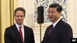 U.S. Treasury Secretary Timothy Geithner, left, shakes hands with Chinese Vice President Xi Jinping at the Great Hall of the People in Beijing, January 11, 2012