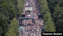 Demonstrators protest the government's restrictions amid the COVID-19 outbreak, in Berlin, Aug. 1, 2020.
