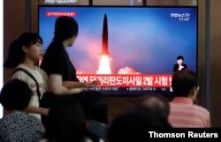 People watch a TV that shows a file picture of a North Korean missile for a news report on North Korea firing short-range ballistic missiles, in Seoul, South Korea, July 31, 2019.