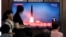  People watch a TV that shows a file picture of a North Korean missile for a news report on North Korea firing short-range ballistic missiles, in Seoul, South Korea, July 31, 2019. 