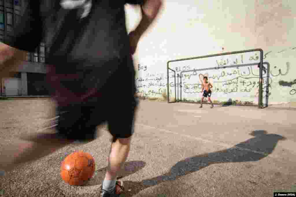 Youngsters play football on the streets of Beirut.