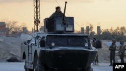 Members of the Syrian Democratic Forces (SDF) deploy outside Ghwayran prison in Syria's northeastern city of Hasakeh on January 26, 2022, after having declared over the facility following its takeover by Islamic State (IS) group forces.