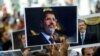 FILE - People hold pictures of Egyptian President Mohamed Morsi during a symbolic funeral ceremony at Fatih mosque in Istanbul, June 18, 2019. 