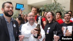 FILE - Members of the activist group Motion of Integration and Gay Liberation celebrate the congressional passage of a bill recognizing civil unions in Valparaiso, Chile, Jan. 28, 2015. Registration of such unions begins this week.