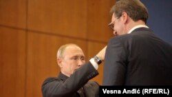 Russian President Vladimir Putin awards Serbian President Aleksandar Vucic with a medal in Belgrade, Serbia, January 17, 2019
