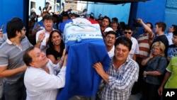 Relatives carry a coffin with the remains of Rodrigo Quintana, a member of the Authentic Radical Liberal Party, who was killed in an incident at party's headquarters away from congress at the party's headquarters on Friday, in Asuncion, Paraguay, April 1,