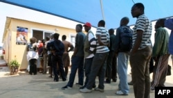 FILE - Zimbabweans deported from Botswana wait at the International Organization for Migration center in Zimbabwe, Sept. 12, 2009. This week, hundreds of Zimbabwean refugees in Botswana were told they must return to their home country. 