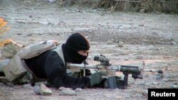 FILE - A U.S. Navy SEAL member provides cover for his teammates advancing on a suspected location of al-Qaida and Taliban forces, Jan. 26, 2002.