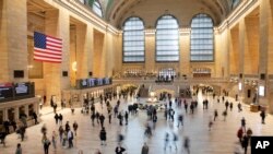 Commuters pass through Grand Central Terminal, Tuesday, March 10, 2020 in New York. Some people are restricting how much they travel due to the concern for COVID-19.